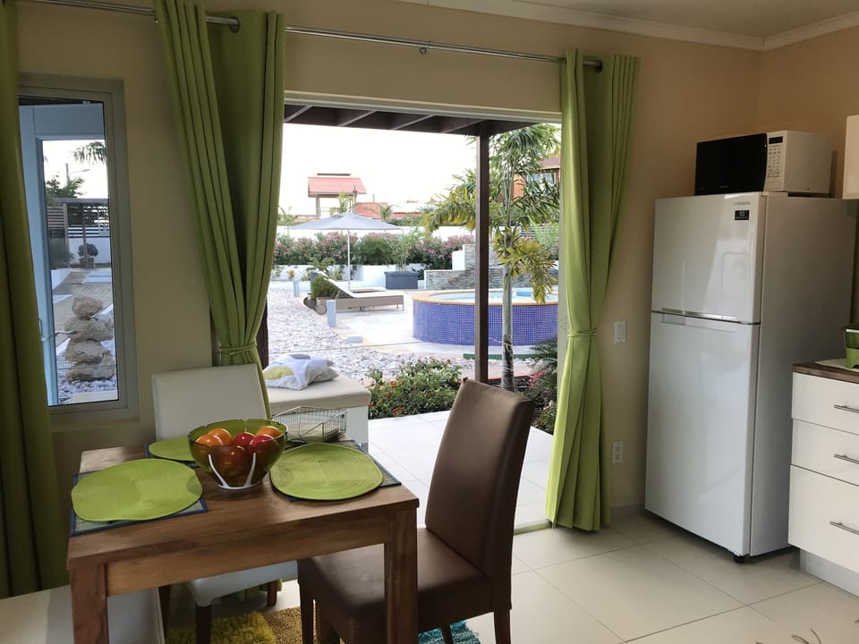 Apartment, 1 Bedroom, Pool View, Poolside | In-room dining