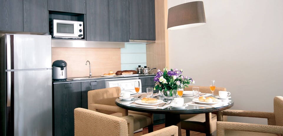 Suite, 1 Bedroom | Private kitchen | Fridge, electric kettle, dining tables