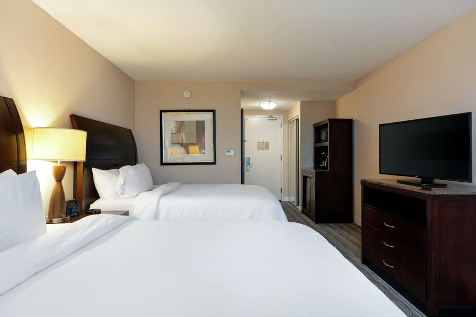 Two queens evolution room | Premium bedding, down comforters, desk, laptop workspace