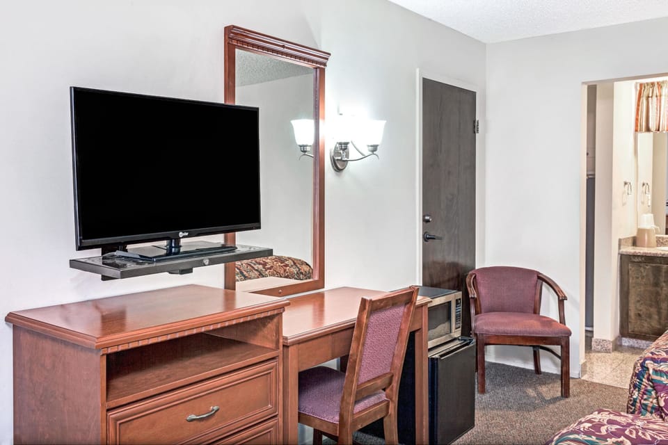 Hypo-allergenic bedding, desk, laptop workspace, blackout drapes
