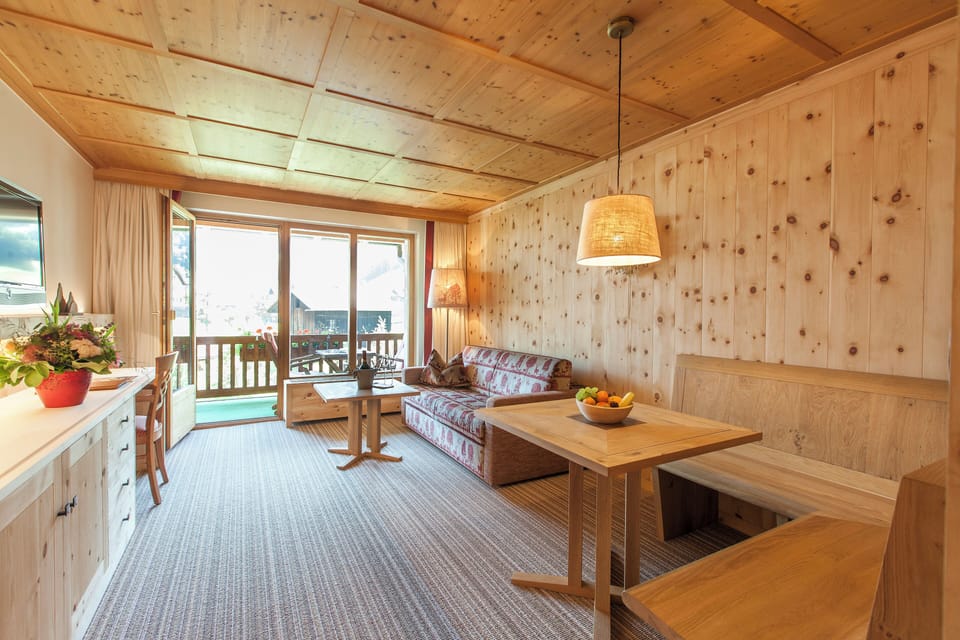 Suite Swiss stone pine 60sqm | Living area | 32-inch flat-screen TV with cable channels, heated floors