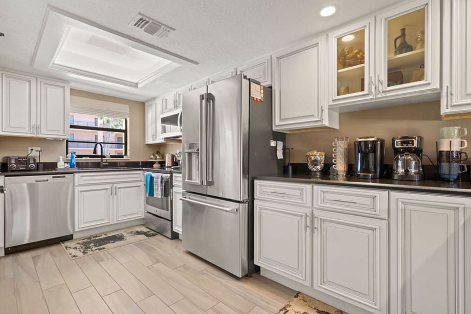 Two-Story Condo w/ Putting Green and Pool Views, Unit #210 | Private kitchen | Fridge, microwave, oven, coffee/tea maker