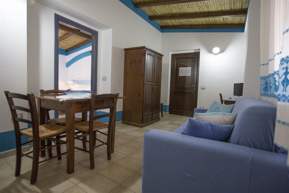 Comfort Apartment, 1 Bedroom | Living area | 22-inch flat-screen TV with digital channels, TV, books