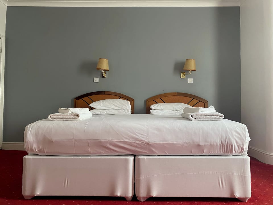 Double Room | Desk, blackout drapes, iron/ironing board, bed sheets