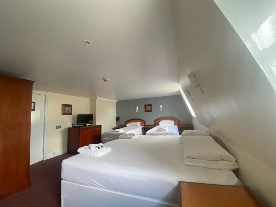 Family Room | Desk, blackout drapes, iron/ironing board, bed sheets