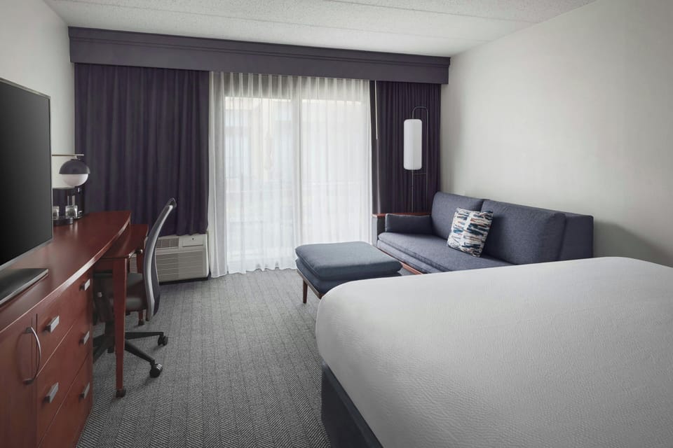 Premium bedding, desk, laptop workspace, iron/ironing board