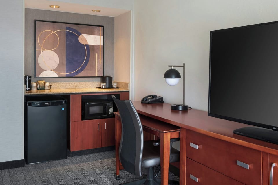 Premium bedding, desk, laptop workspace, iron/ironing board