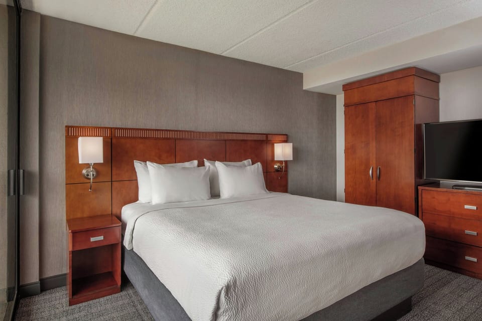 Hypo-allergenic bedding, desk, laptop workspace, blackout drapes