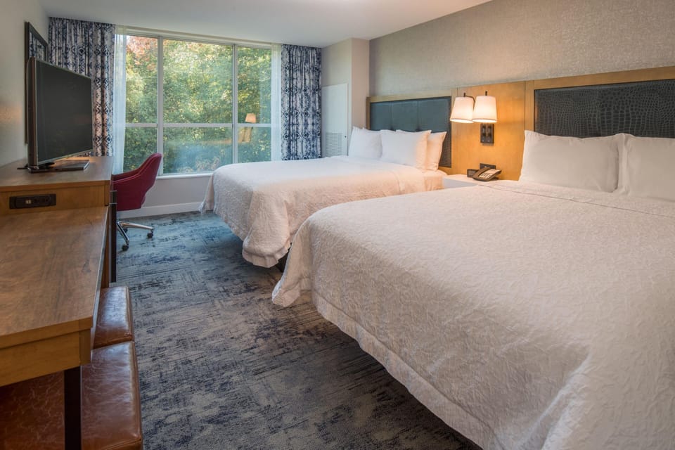 Hypo-allergenic bedding, desk, laptop workspace, blackout drapes