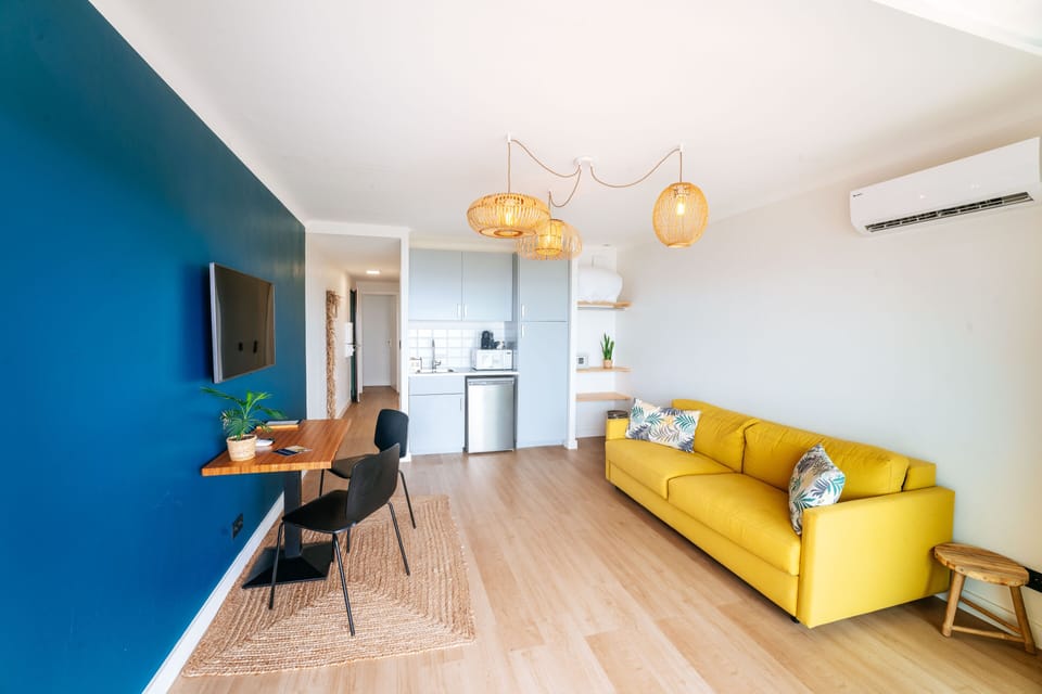 Comfort Apartment | Living area | Flat-screen TV, books