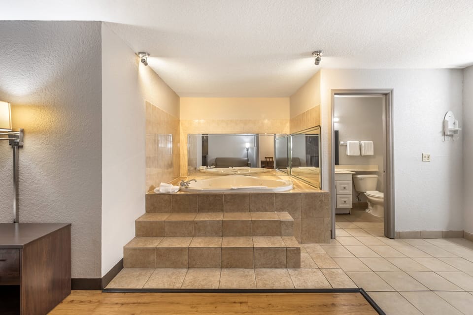 Suite, 1 King Bed, Smoking, Jetted Tub | Desk, laptop workspace, blackout drapes, free cribs/infant beds