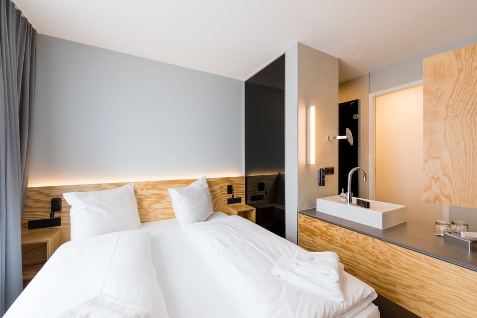 Hypo-allergenic bedding, desk, laptop workspace, blackout drapes