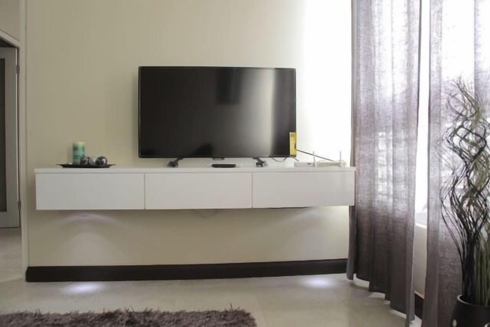 City Apartment, 2 Bedrooms, Refrigerator & Microwave, City View | Living room | 50-inch flat-screen TV with cable channels, TV, DVD player