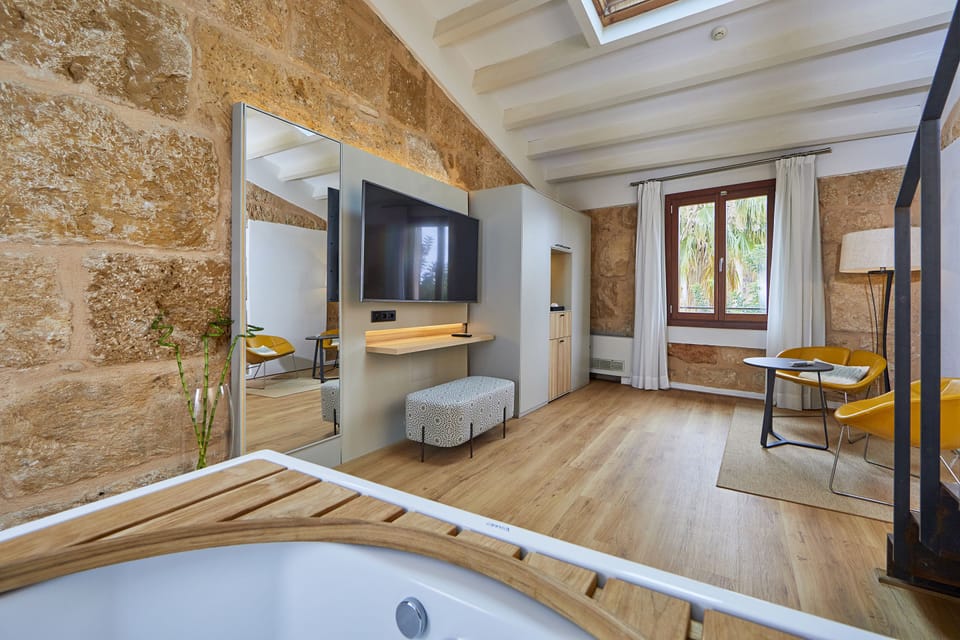 Suite, Garden View | Minibar, in-room safe, blackout drapes, iron/ironing board