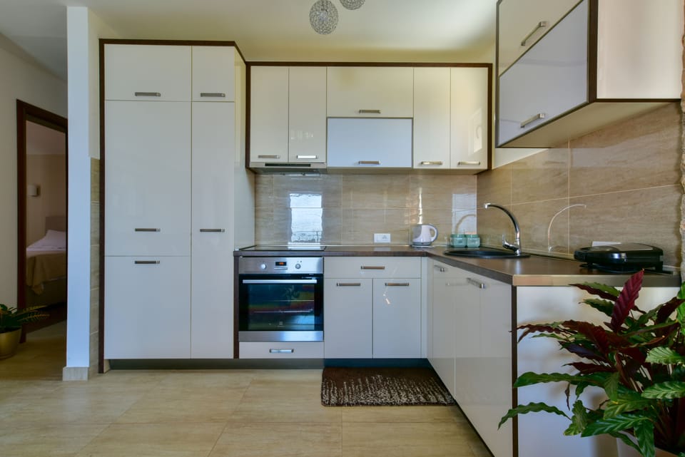 Deluxe Apartment, 2 Bedrooms, Sea View | Private kitchen | Coffee/tea maker, fridge, stovetop, electric kettle