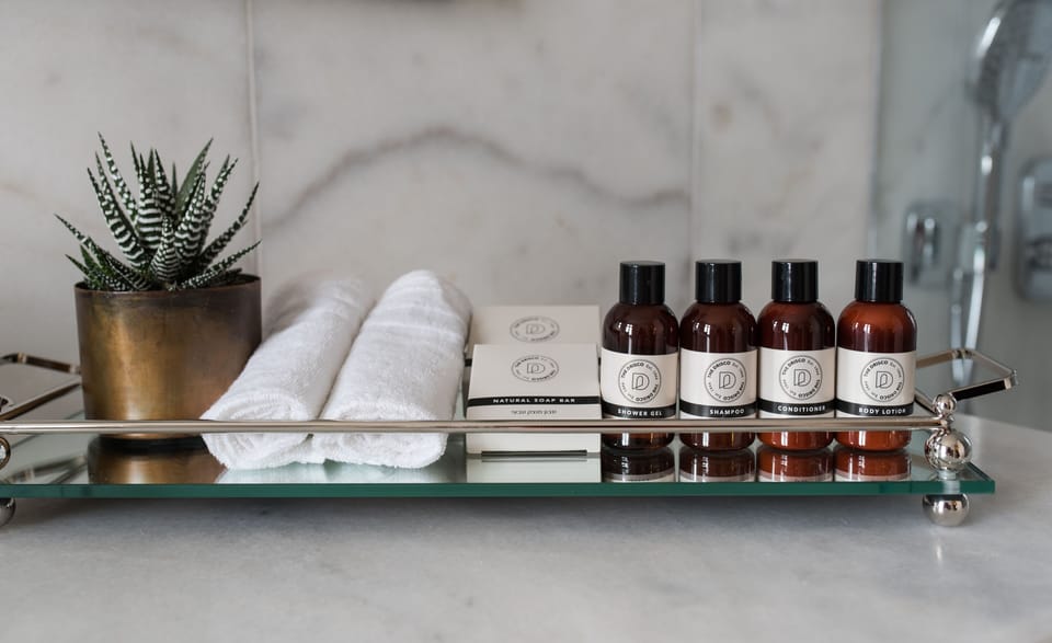 Designer toiletries, hair dryer, bathrobes, slippers