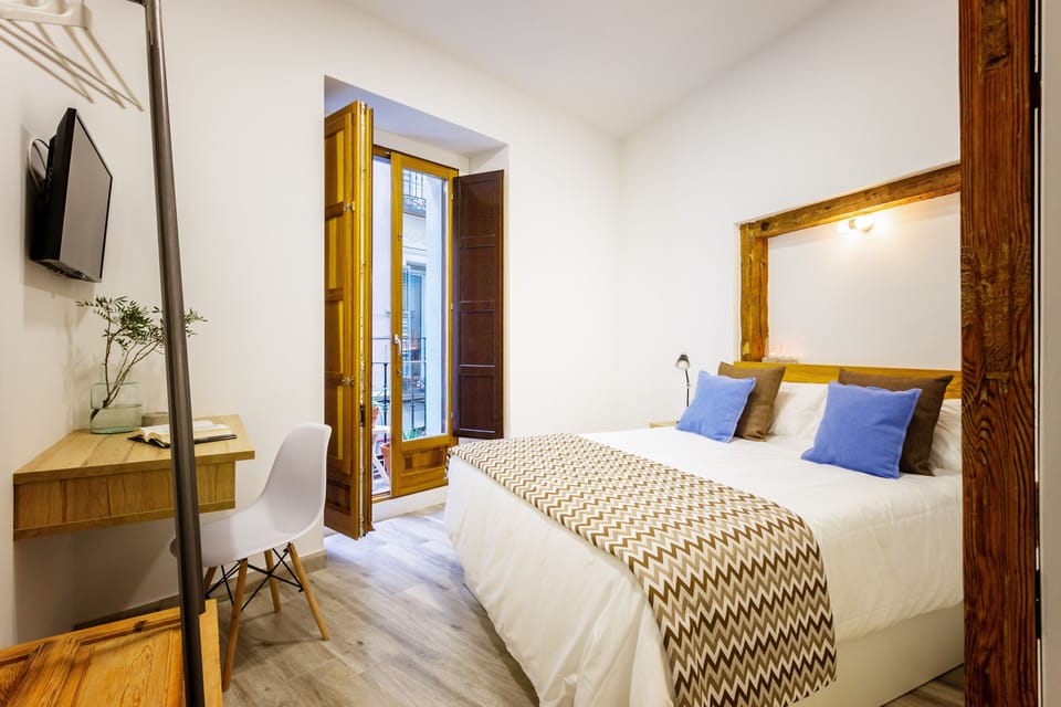 Premium bedding, desk, laptop workspace, blackout drapes