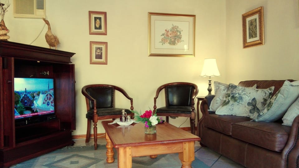 Suite with garden view | Living area | Flat-screen TV