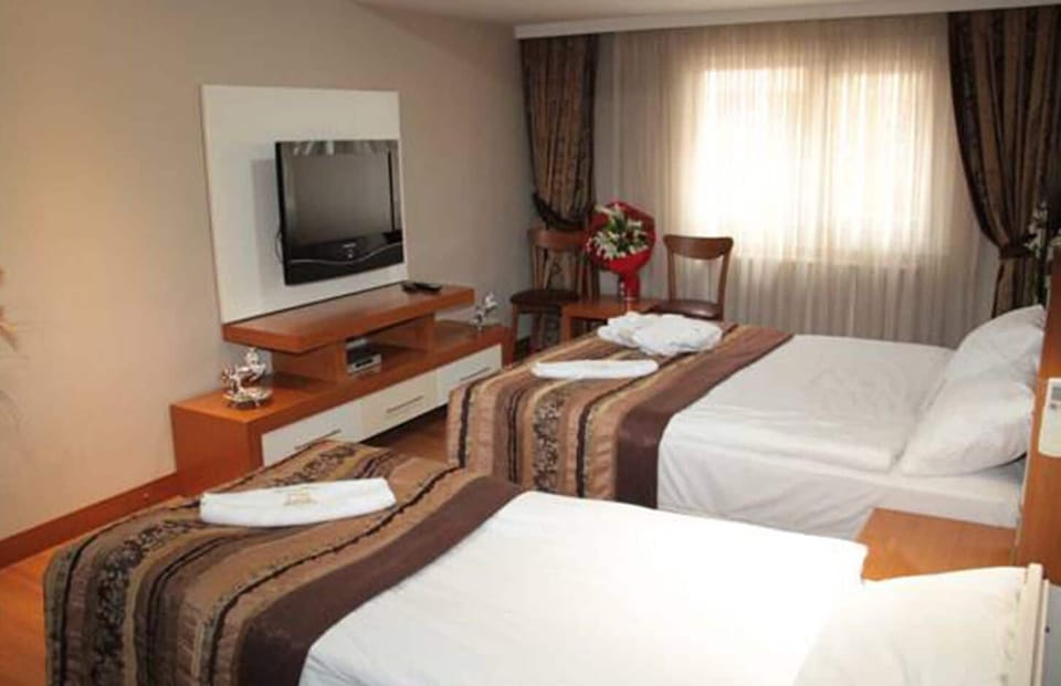 Standard Triple Room | Minibar, in-room safe, soundproofing, iron/ironing board