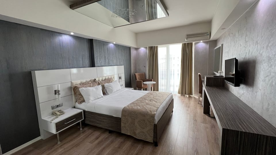 Superior Room with Balcony | Minibar, in-room safe, desk, laptop workspace