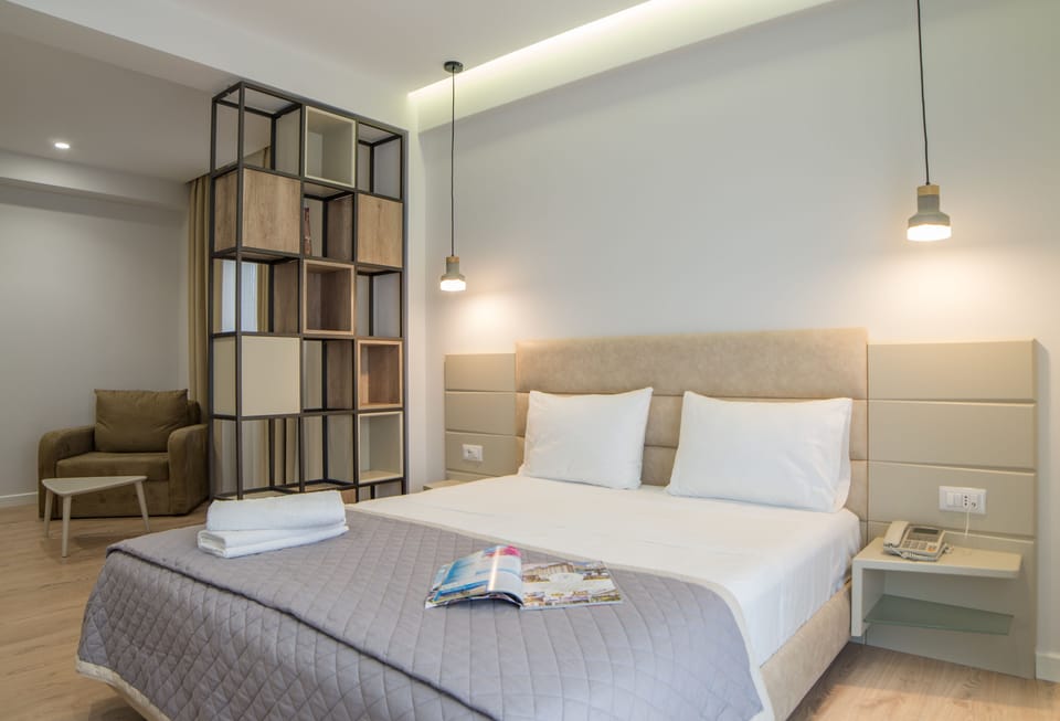 Deluxe Suite, Partial Sea View | Hypo-allergenic bedding, in-room safe, desk, blackout drapes