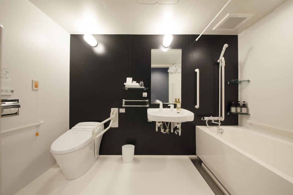 Combined shower/tub, free toiletries, hair dryer, slippers