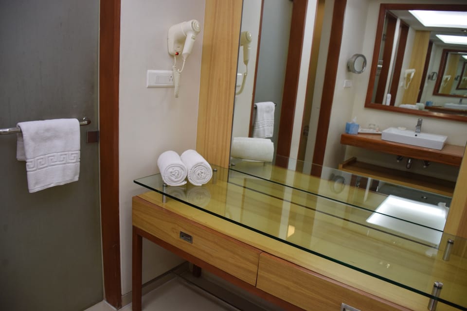 Quadruple Room with Garden View - Complimentary Shuttle Pickup and Drop to Sai Baba Temple (Gate 2) | Bathroom | Shower, free toiletries, bathrobes, slippers