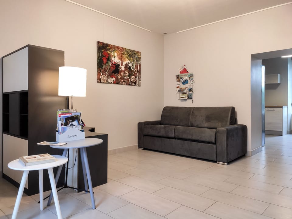 Standard Townhome, Garden View | Living area | Flat-screen TV