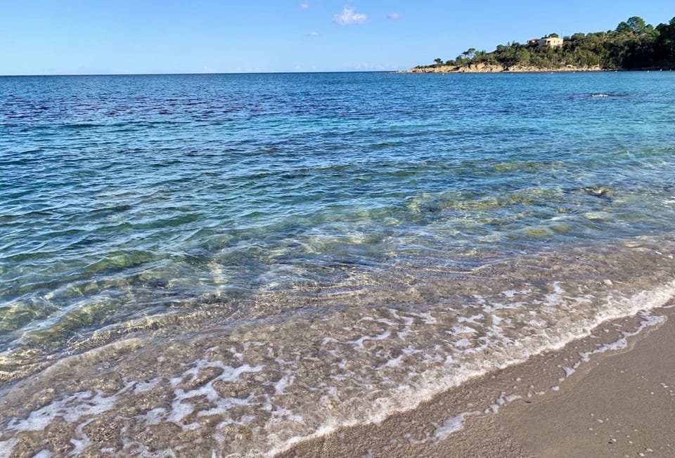 Beach nearby, white sand, beach umbrellas, beach towels