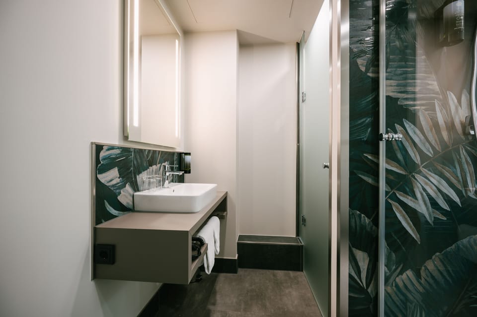 Shower, rainfall showerhead, hair dryer, towels