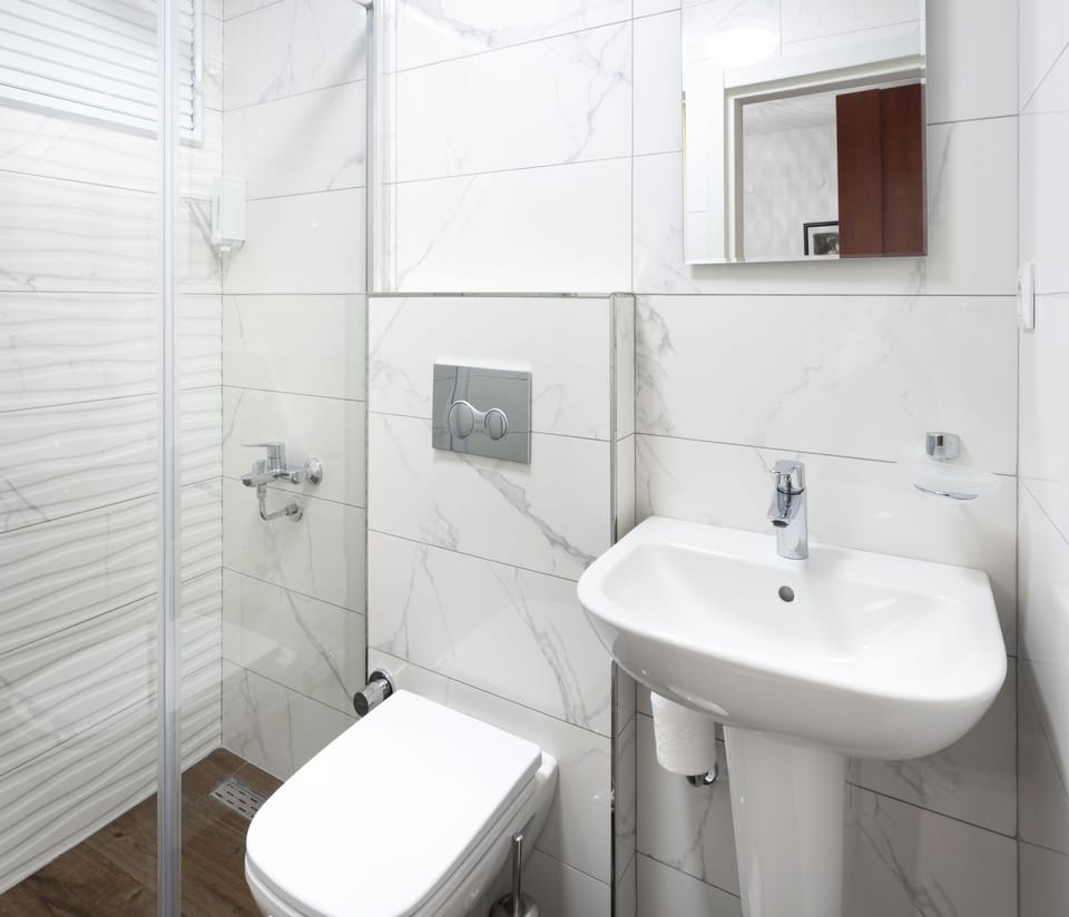 Economy Double Room (Basement) | Bathroom | Shower, free toiletries, hair dryer, towels