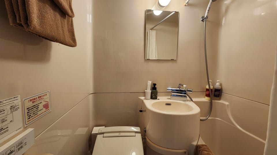 Combined shower/tub, free toiletries, hair dryer, slippers