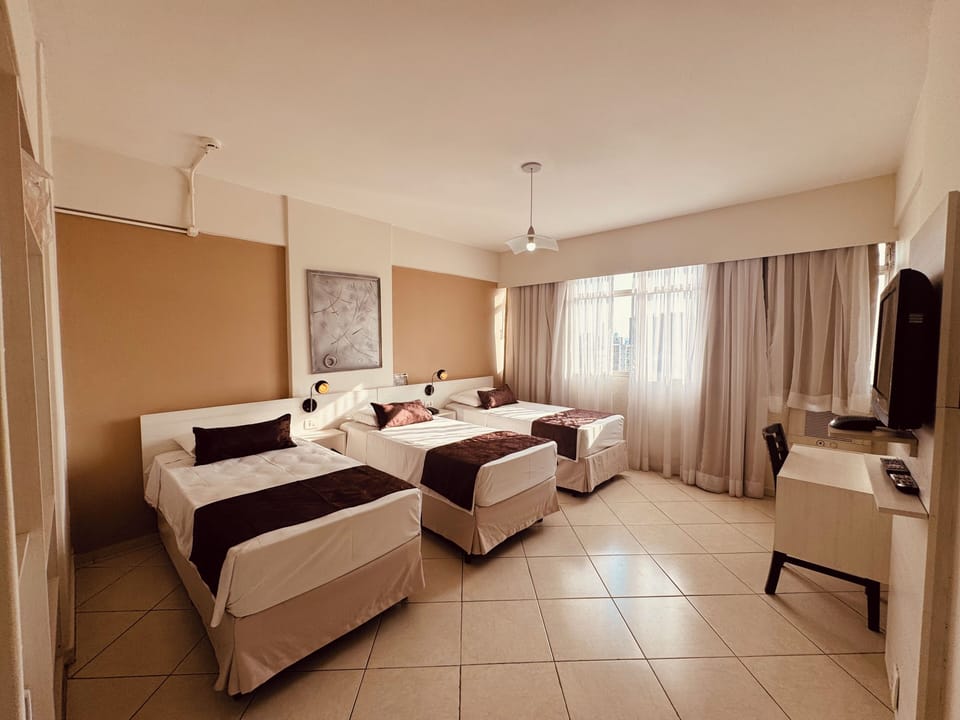 Standard Triple Room | Minibar, desk, laptop workspace, blackout drapes