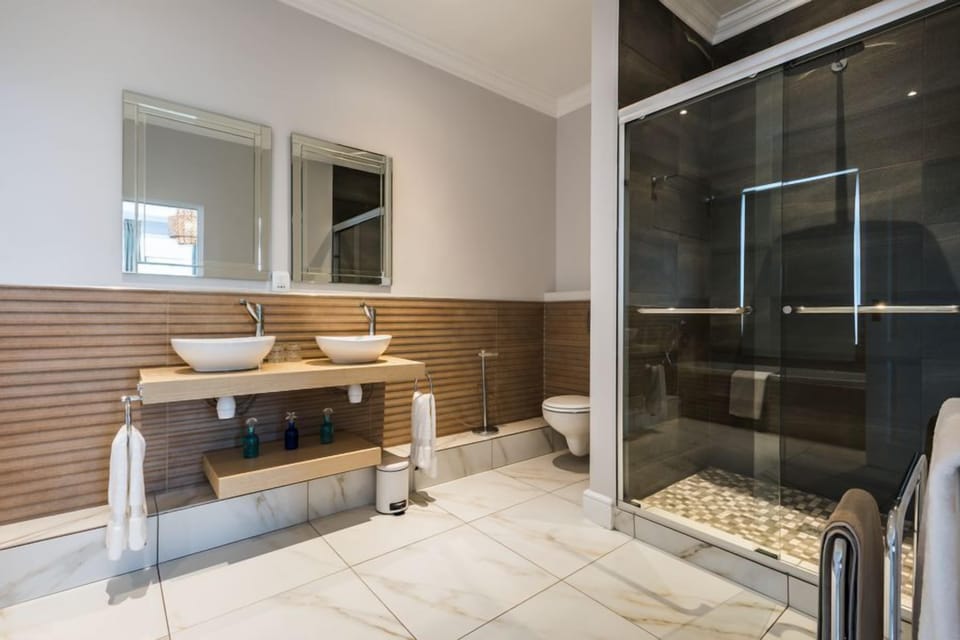False Bay Suite | Bathroom | Shower, rainfall showerhead, hair dryer, bathrobes