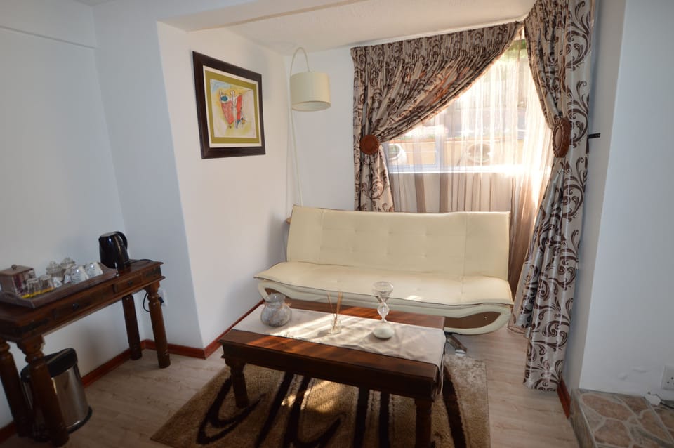 Spacious Deluxe | Living area | 32-inch TV with satellite channels