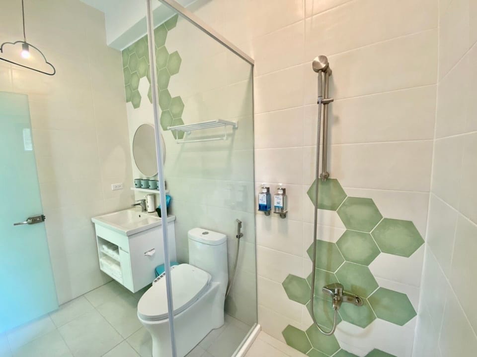 Quadruple Room | Bathroom | Shower, hair dryer, slippers, towels