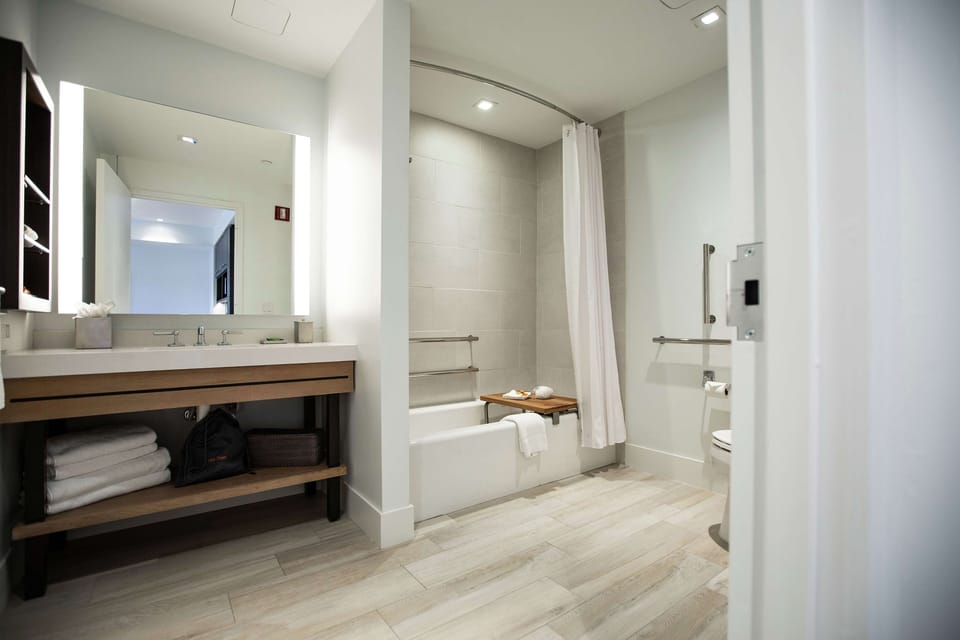 Room, 1 King Bed, Accessible, Corner (Mobility & Hearing, Bathtub) | Bathroom | Combined shower/tub, free toiletries, hair dryer, towels