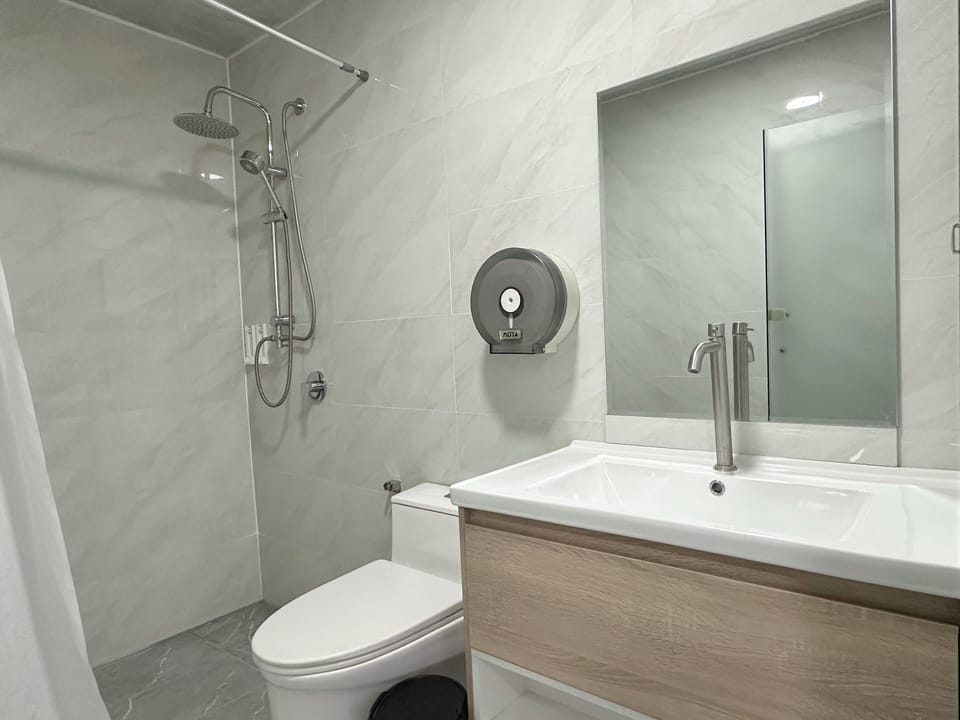 Family Suite | Bathroom | Shower, slippers, towels, soap