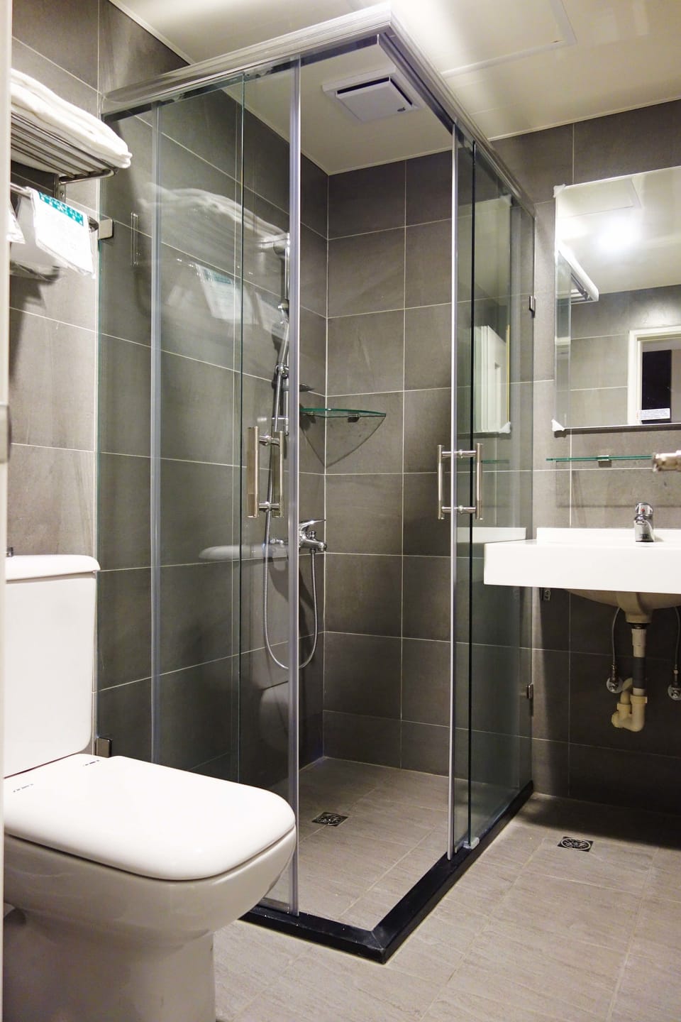 Shower, hair dryer, slippers, towels