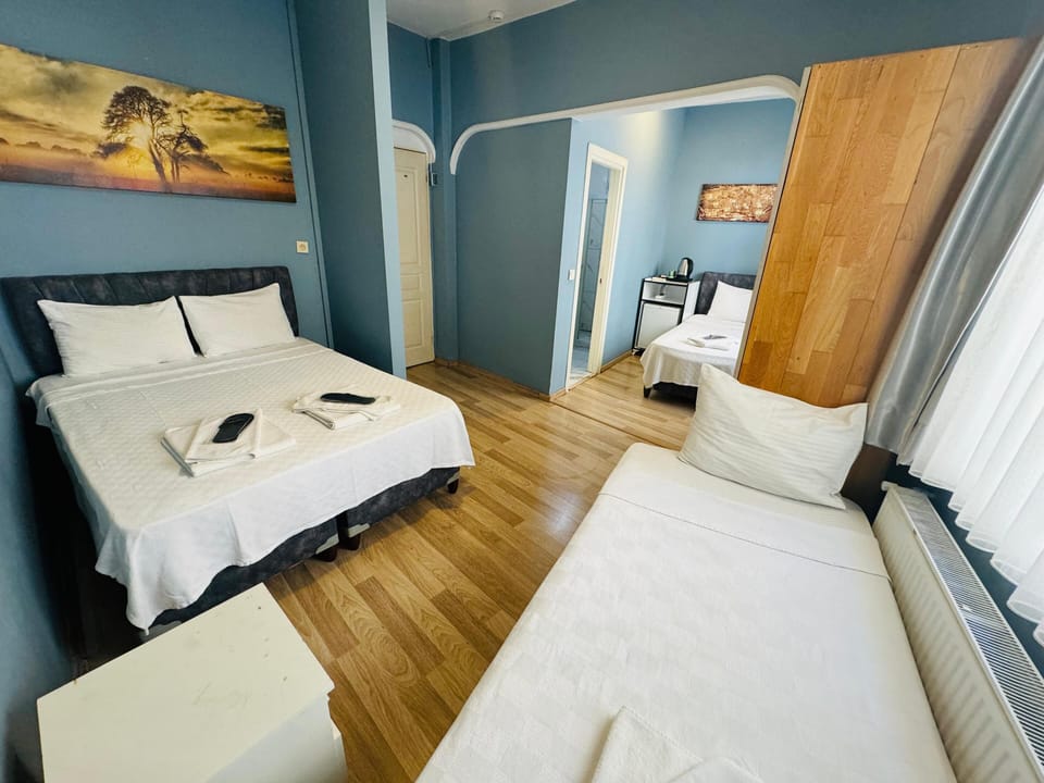 Standard Quadruple Room | Minibar, in-room safe, desk, iron/ironing board