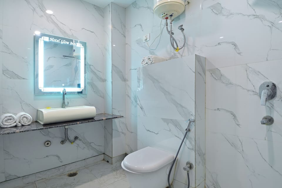 Shower, designer toiletries, towels, toilet paper