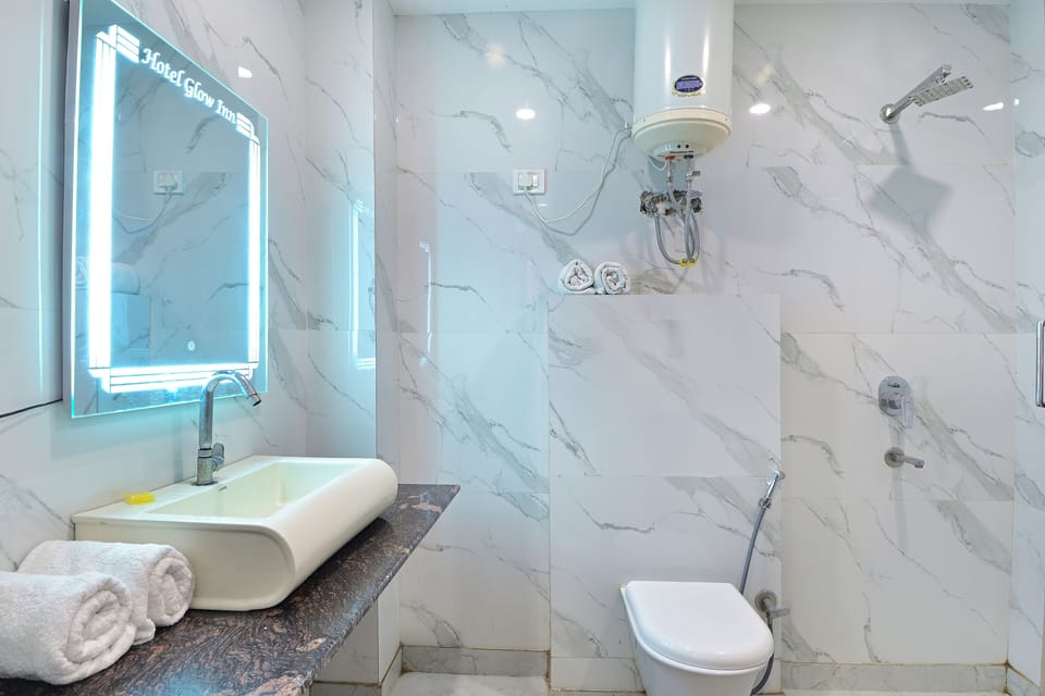 Shower, designer toiletries, towels, toilet paper