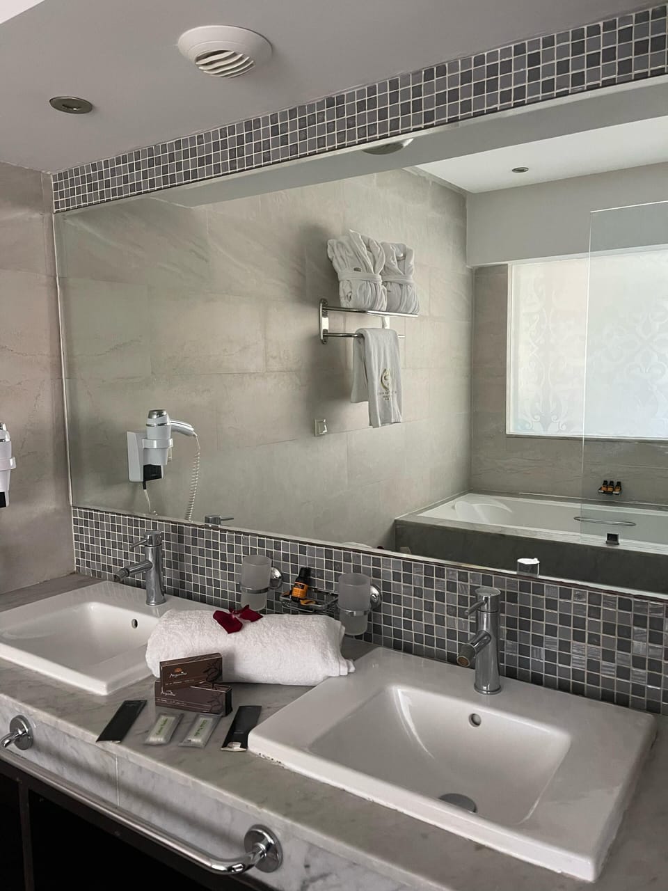 Deep soaking tub, rainfall showerhead, designer toiletries, hair dryer