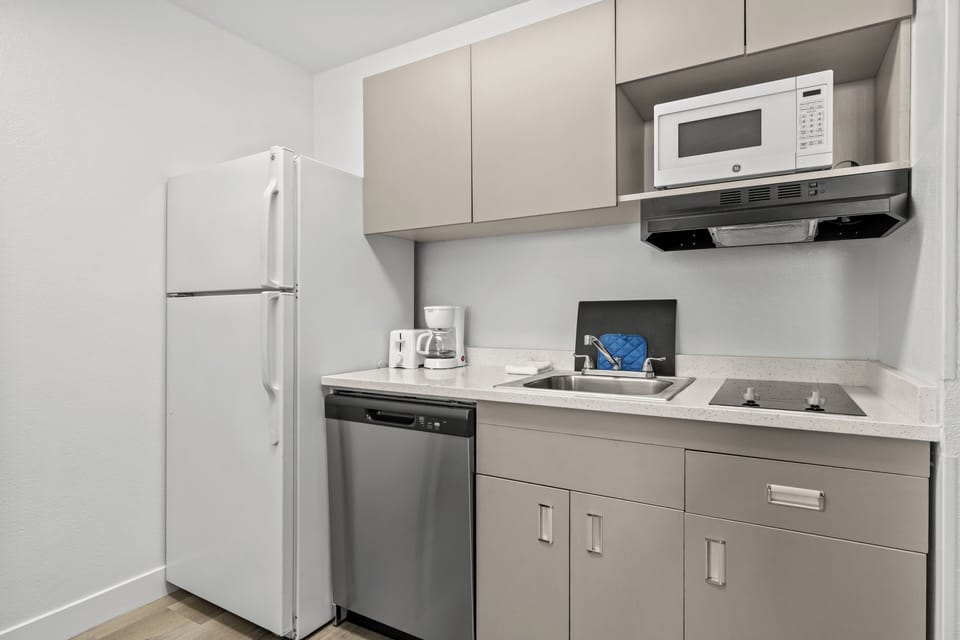 Suite, 1 Queen Bed, Non Smoking | Private kitchen | Full-size fridge, microwave, stovetop, cookware/dishes/utensils