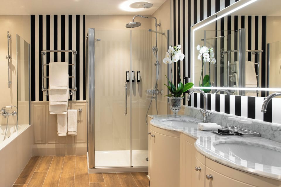 Signature Junior Suite | Bathroom | Designer toiletries, hair dryer, bathrobes, slippers
