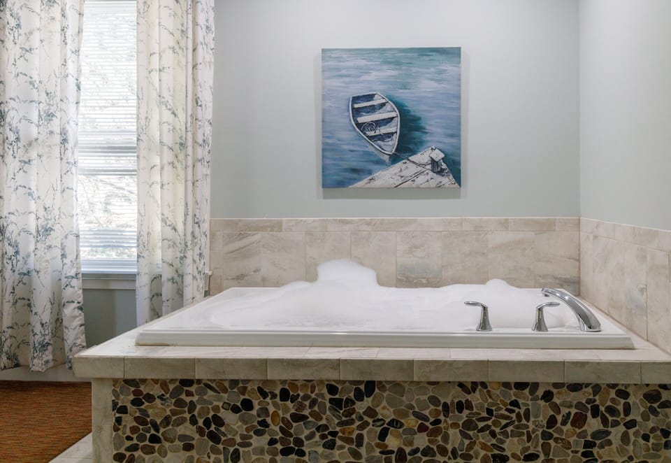 King with Jetted Tub and Fireplace Compass Rose Building | Private spa tub