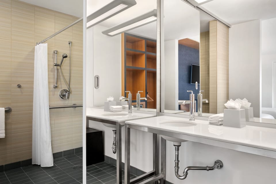 Shower, designer toiletries, hair dryer, towels