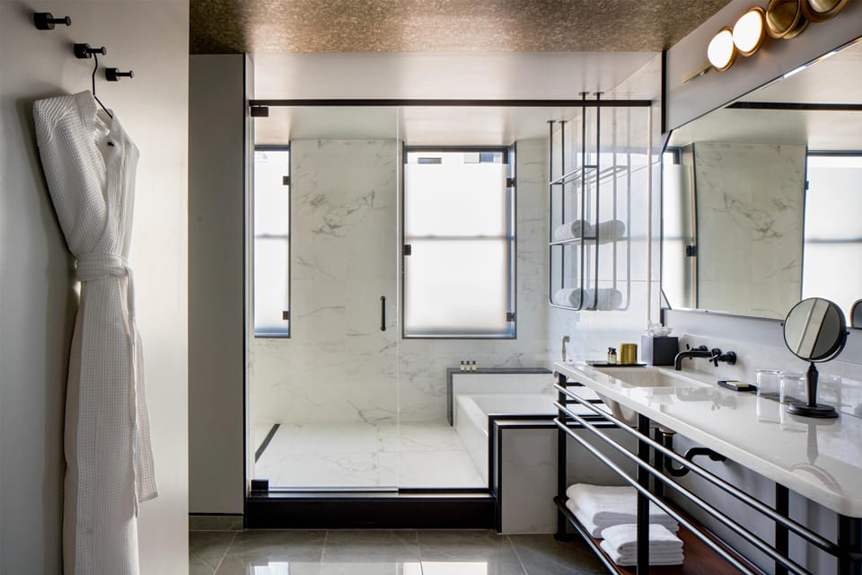 Shower, designer toiletries, hair dryer, slippers
