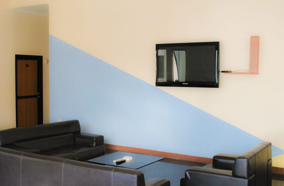 Economy Double Room, 1 Queen Bed | Living area | 24-inch LCD TV with satellite channels, TV