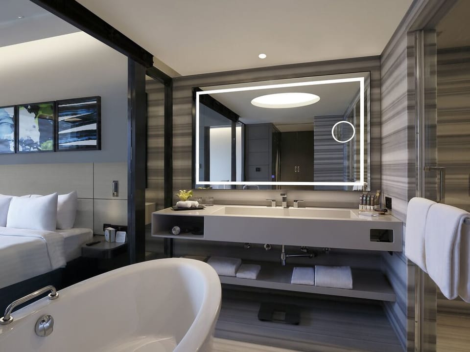 Luxury Suite with One Way Airport Transfer, Separate Living Room and Bathtub | Bathroom | Eco-friendly toiletries, hair dryer, slippers, towels